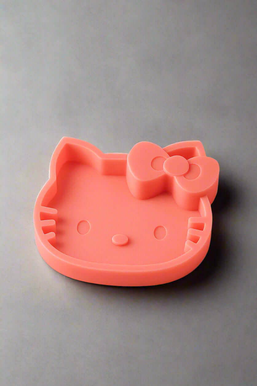 Pink Hello Kitty catch-all tray with a cute bow, perfect for organizing small items.