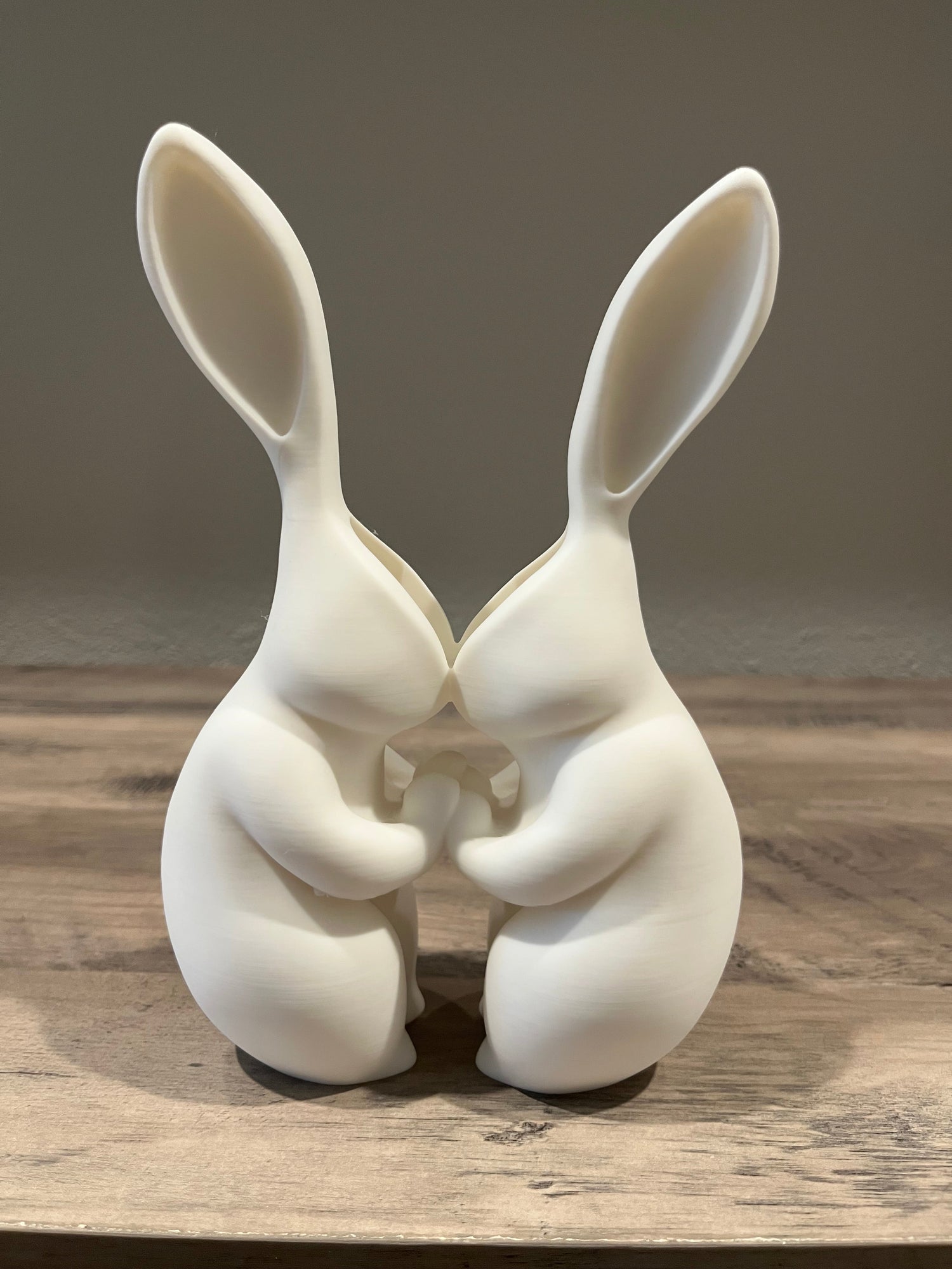 A planter shaped like 2 bunnies in a loving embrace 