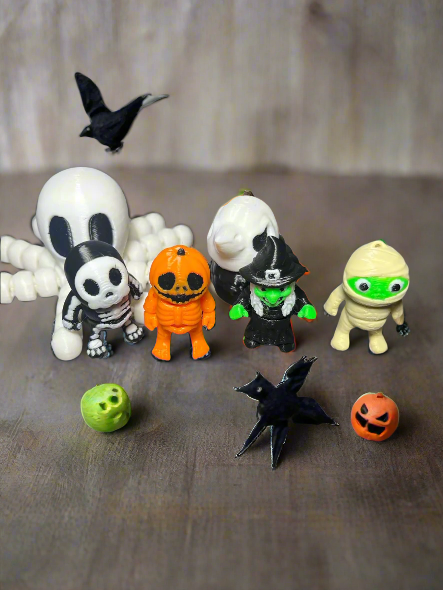 Halloween-themed figurines on a wooden surface with a blurred background